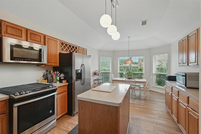 1801 Bent Brook Dr, Mesquite, TX 75181 - kitchen featuring stainless steel appliances, light countertops, light wood-type flooring, and pendant lighting