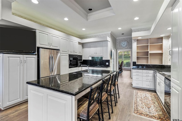 13735 Peninsula Rd, Whitehouse, TX 75791 - kitchen with crown molding, black appliances, open shelves, light wood-type flooring, and a breakfast bar