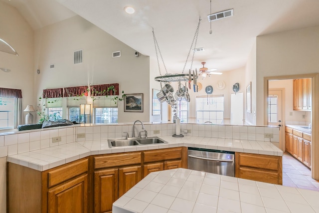 3148 Fm 66, Waxahachie, TX 75167 - kitchen featuring stainless steel dishwasher, open floor plan, ceiling fan, tile counters, and high vaulted ceiling