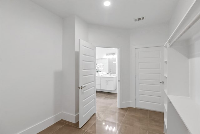 154 S Cisco St, Dallas, TX 75246 - walk in closet with light tile patterned flooring and a sink