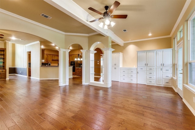 3506 Ash Cir, Richardson, TX 75082 - unfurnished living room with ornate columns, ceiling fan, arched walkways, light wood-type flooring, and ornamental molding