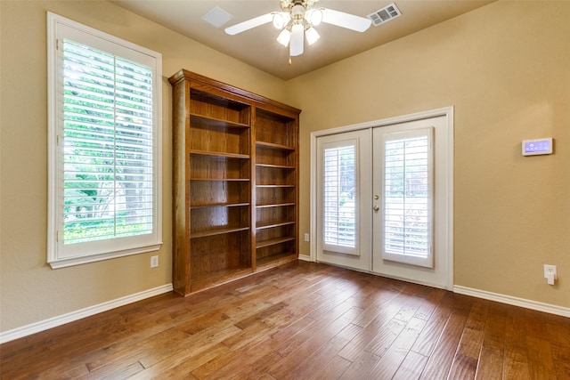 3506 Ash Cir, Richardson, TX 75082 - empty room featuring french doors, wood finished floors, plenty of natural light, and a ceiling fan