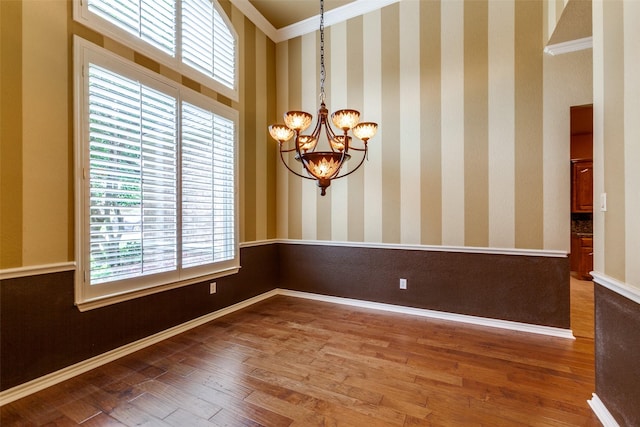 3506 Ash Cir, Richardson, TX 75082 - unfurnished room with a chandelier, wood finished floors, and ornamental molding