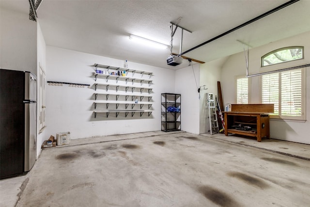 3506 Ash Cir, Richardson, TX 75082 - garage with freestanding refrigerator and a garage door opener