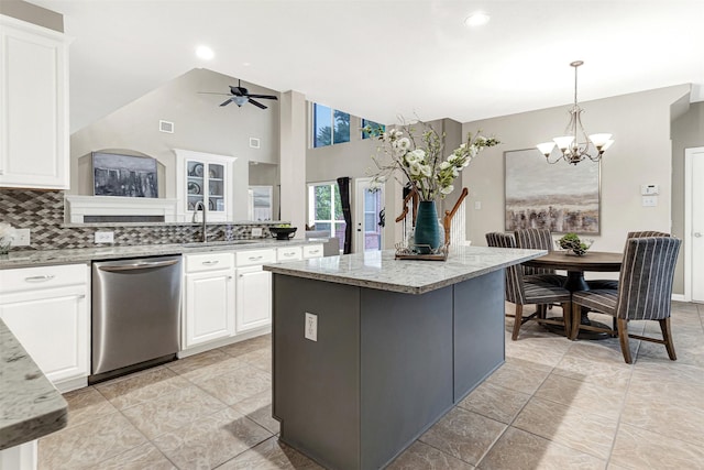 4512 Greenfield Dr, Richardson, TX 75082 - kitchen with dishwasher, a kitchen island, white cabinets, a chandelier, and lofted ceiling
