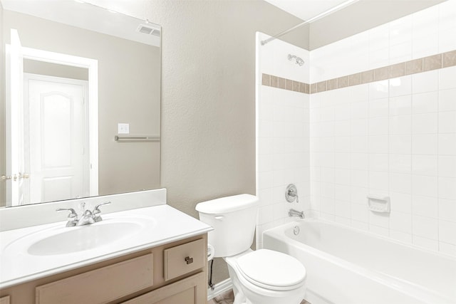 4512 Greenfield Dr, Richardson, TX 75082 - bathroom featuring a textured wall, vanity, and shower / washtub combination