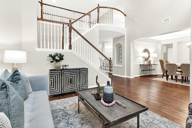 4512 Greenfield Dr, Richardson, TX 75082 - living area featuring wood finished floors, stairway, a towering ceiling, and arched walkways