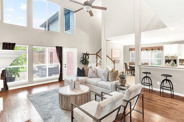 4512 Greenfield Dr, Richardson, TX 75082 - living room featuring stairs, wood finished floors, a ceiling fan, and a towering ceiling