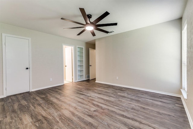 1902 Vassar Dr, Richardson, TX 75081 - spare room featuring a ceiling fan, wood finished floors, and built in features