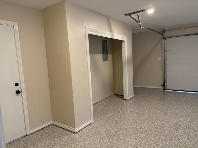1902 Vassar Dr, Richardson, TX 75081 - garage featuring baseboards and electric panel