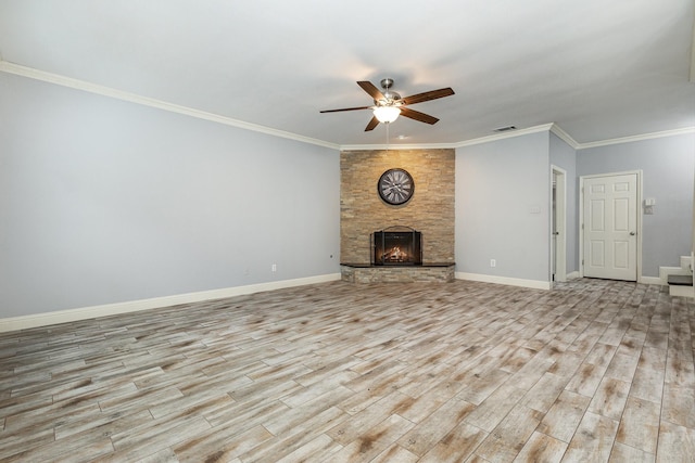 838 Bear Branch Ct, Rockwall, TX 75087 - unfurnished living room featuring ceiling fan, light wood finished floors, ornamental molding, a stone fireplace, and stairway