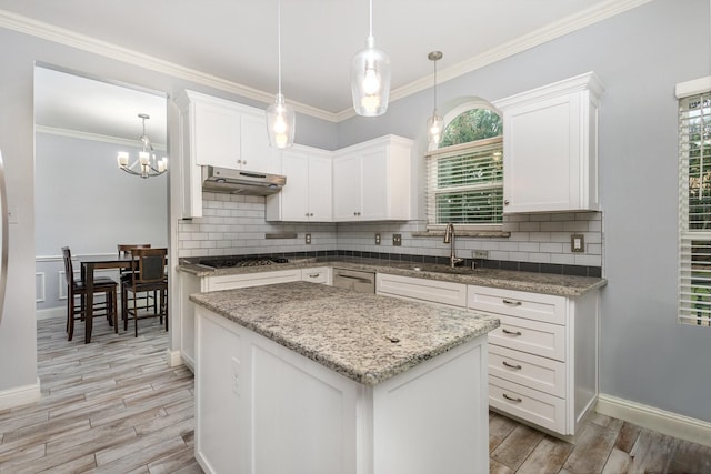 838 Bear Branch Ct, Rockwall, TX 75087 - kitchen with under cabinet range hood, light wood-style flooring, backsplash, white cabinetry, and ornamental molding