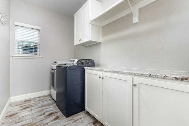 838 Bear Branch Ct, Rockwall, TX 75087 - laundry room with washer and dryer, cabinet space, and light wood-style floors