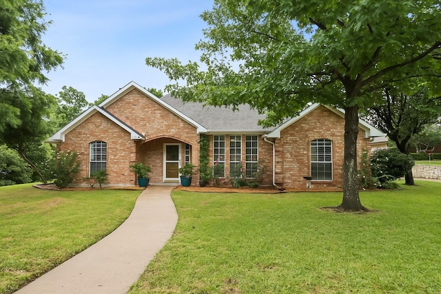 312 Bluffview Ct, Forney, TX 75126 - view of front of house with brick siding, a front lawn, and a shingled roof
