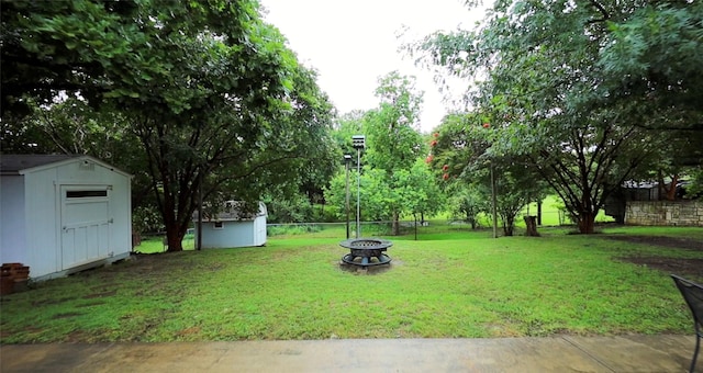 312 Bluffview Ct, Forney, TX 75126 - fenced backyard with a storage unit and an outdoor fire pit
