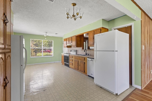 1206 Fm 902, Howe, TX 75090 - kitchen featuring freestanding refrigerator, range with electric cooktop, stainless steel dishwasher, a chandelier, and a textured ceiling
