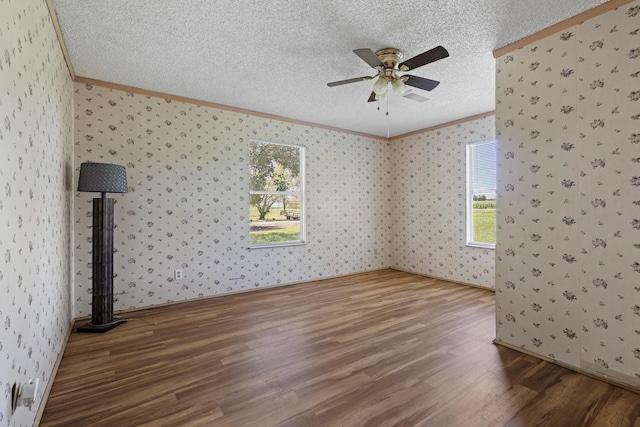 1206 Fm 902, Howe, TX 75090 - empty room with ornamental molding, wood finished floors, a ceiling fan, a textured ceiling, and wallpapered walls