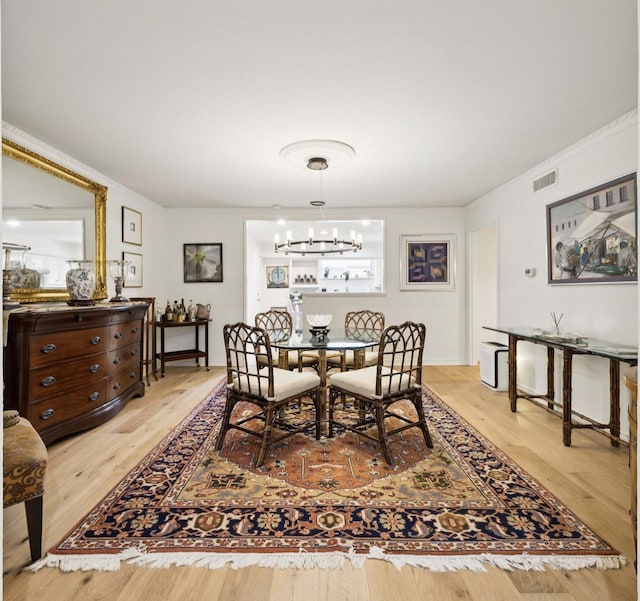 6227 Bandera Ave Unit D, Dallas, TX 75225 - dining room with wood finished floors, ornamental molding, and a chandelier