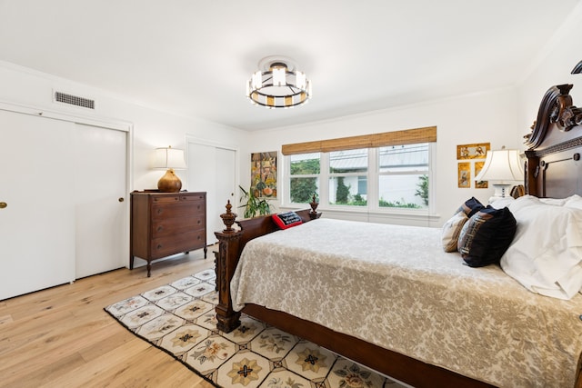 6227 Bandera Ave Unit D, Dallas, TX 75225 - bedroom with light wood-style flooring, multiple closets, and crown molding