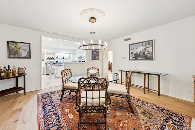 6227 Bandera Ave Unit D, Dallas, TX 75225 - dining area featuring a chandelier, light wood-style flooring, ornamental molding, and recessed lighting