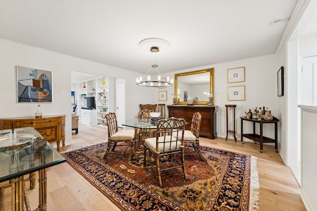 6227 Bandera Ave Unit D, Dallas, TX 75225 - dining area featuring light wood-style floors, a chandelier, crown molding, and built in shelves
