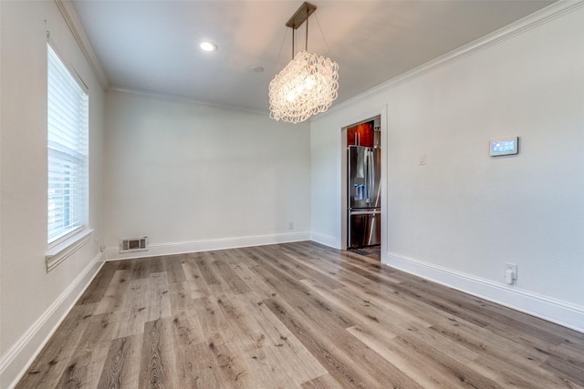 11329 Mccree Rd, Dallas, TX 75238 - empty room with a chandelier, crown molding, and wood finished floors