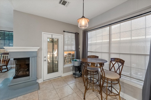 2213 Laura Elizabeth Trl, Mansfield, TX 76063 - dining room featuring light tile patterned flooring and a multi sided fireplace