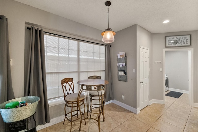 2213 Laura Elizabeth Trl, Mansfield, TX 76063 - dining area with healthy amount of natural light, a textured ceiling, light tile patterned floors, recessed lighting, and washer / clothes dryer
