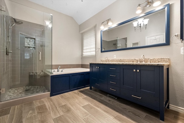 2213 Laura Elizabeth Trl, Mansfield, TX 76063 - full bathroom with lofted ceiling, a stall shower, double vanity, a garden tub, and a chandelier