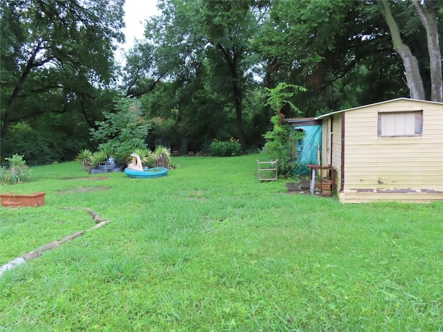 9066 Orinoco Dr, Dallas, TX 75217 - view of green lawn featuring a storage shed