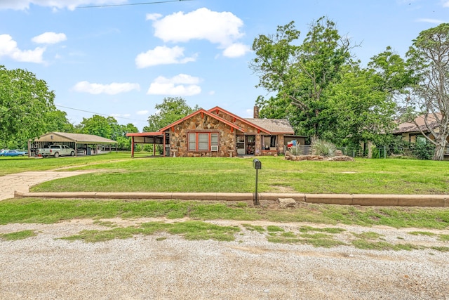 509 W Reynosa Ave, De Leon, TX 76444 - view of front of property with stone siding, driveway, a chimney, a detached carport, and a front lawn