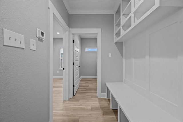 13017 Rainier, Woodway, TX 76712 - mudroom with light wood-type flooring, a textured wall, and crown molding