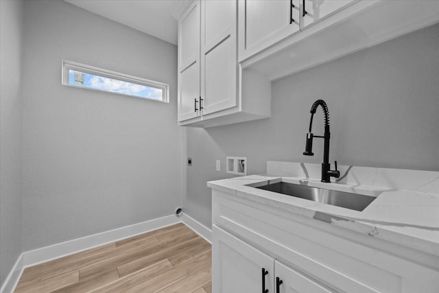 13017 Rainier, Woodway, TX 76712 - laundry room with electric dryer hookup, cabinet space, hookup for a washing machine, and light wood-style floors