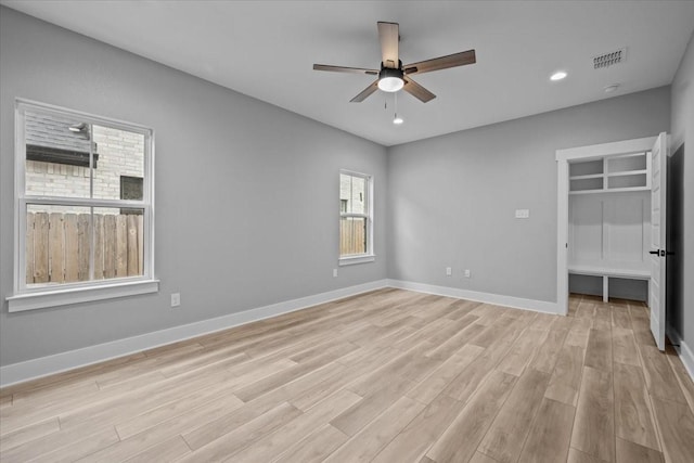 13017 Rainier, Woodway, TX 76712 - unfurnished bedroom featuring light wood finished floors, a walk in closet, recessed lighting, and a ceiling fan