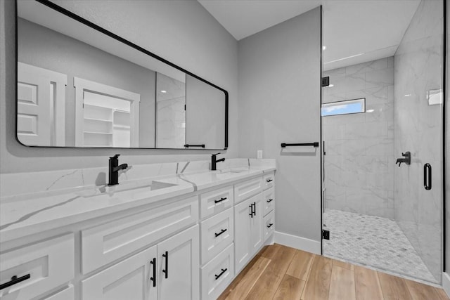 13017 Rainier, Woodway, TX 76712 - bathroom featuring double vanity, a marble finish shower, and wood finished floors