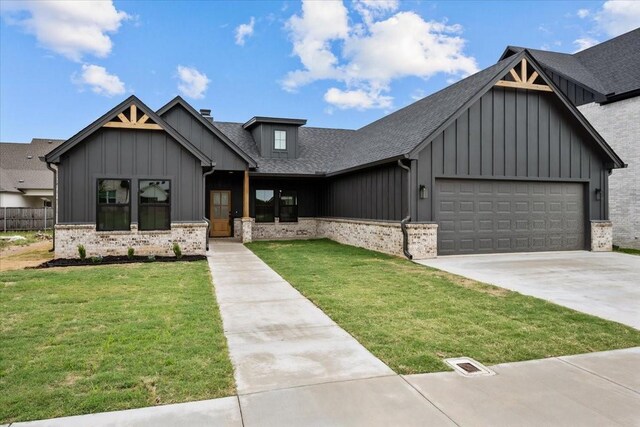 13017 Rainier, Woodway, TX 76712 - modern farmhouse style home featuring board and batten siding, a front yard, a garage, roof with shingles, and concrete driveway