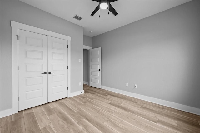 13017 Rainier, Woodway, TX 76712 - unfurnished bedroom with light wood-style flooring, a closet, and a ceiling fan