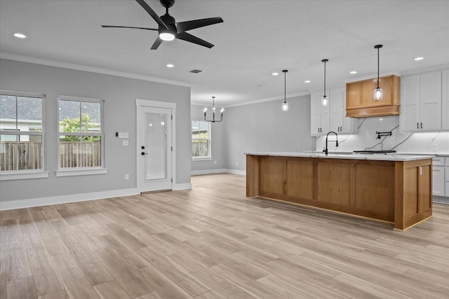 13017 Rainier, Woodway, TX 76712 - kitchen with crown molding, light countertops, a chandelier, recessed lighting, and light wood-type flooring