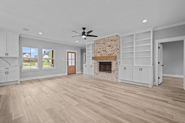 13017 Rainier, Woodway, TX 76712 - unfurnished living room featuring ornamental molding, a brick fireplace, ceiling fan, light wood finished floors, and recessed lighting
