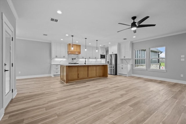 13017 Rainier, Woodway, TX 76712 - kitchen with open floor plan, stainless steel refrigerator with ice dispenser, light countertops, recessed lighting, and ornamental molding