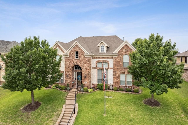 4105 Claridge Ter, Garland, TX 75043 - view of front of house featuring brick siding, a front yard, and a shingled roof
