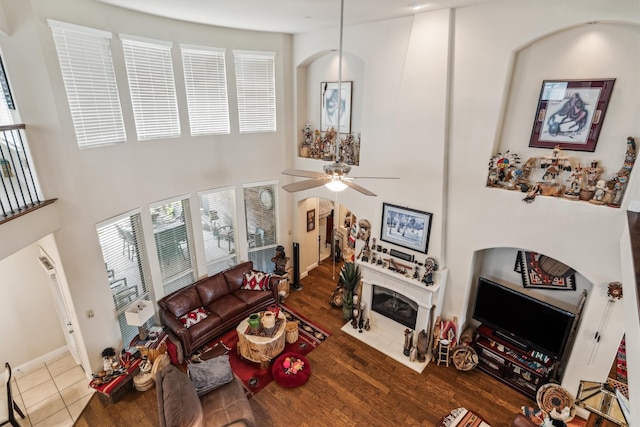 4105 Claridge Ter, Garland, TX 75043 - living room with plenty of natural light, a high ceiling, wood finished floors, a ceiling fan, and arched walkways