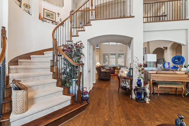 4105 Claridge Ter, Garland, TX 75043 - entrance foyer featuring hardwood / wood-style flooring, a high ceiling, arched walkways, and stairs