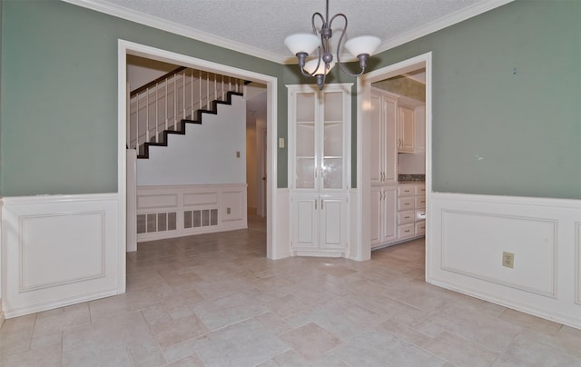 748 Arbor Creek Dr, Desoto, TX 75115 - unfurnished dining area with a decorative wall, stairway, a chandelier, wainscoting, and light stone finish flooring