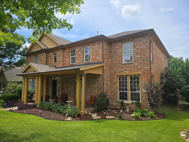 1717 E Branch Hollow Dr, Carrollton, TX 75007 - rear view of property featuring brick siding and a lawn