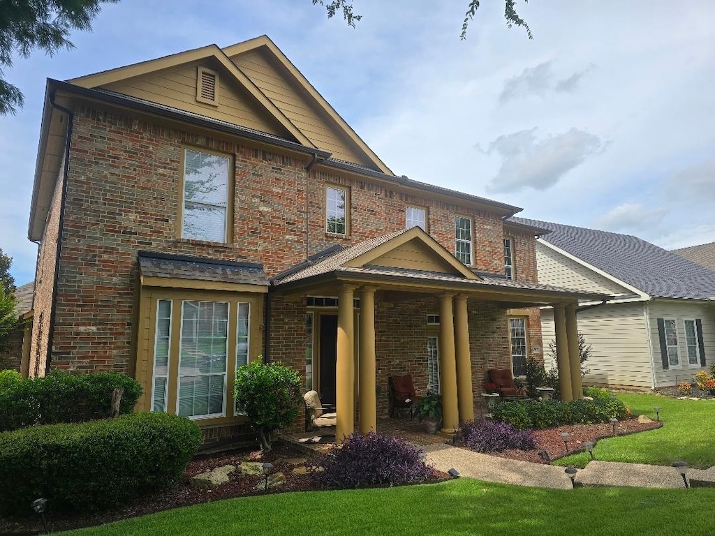 1717 E Branch Hollow Dr, Carrollton, TX 75007 - view of front of home featuring brick siding and a front yard