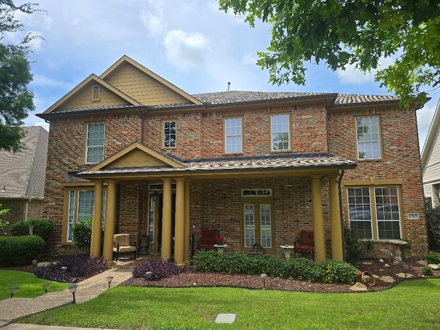 1717 E Branch Hollow Dr, Carrollton, TX 75007 - view of front facade featuring a front yard and brick siding