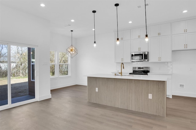 408 Grayson, Leonard, TX 75452 - kitchen featuring appliances with stainless steel finishes, light wood-style flooring, recessed lighting, backsplash, and white cabinets