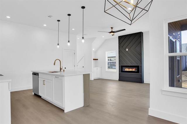 408 Grayson, Leonard, TX 75452 - kitchen featuring light wood-style floors, white cabinets, hanging light fixtures, open floor plan, and stainless steel dishwasher