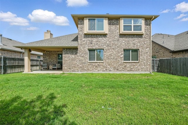 1008 Snowbird Dr, Little Elm, TX 75068 - rear view of house featuring brick siding, a patio, a fenced backyard, and a chimney